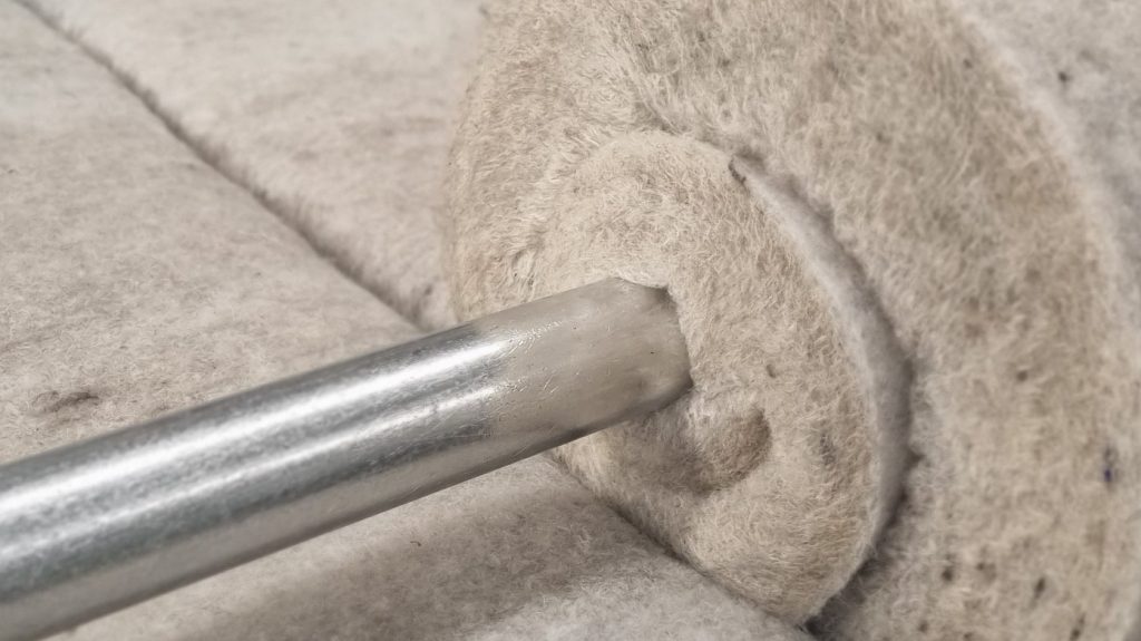 Rolled recycled material on metal rod